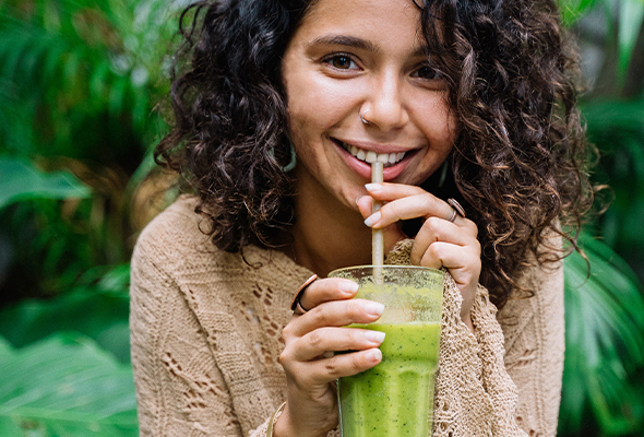 Green and Blush woman drinking smoothie